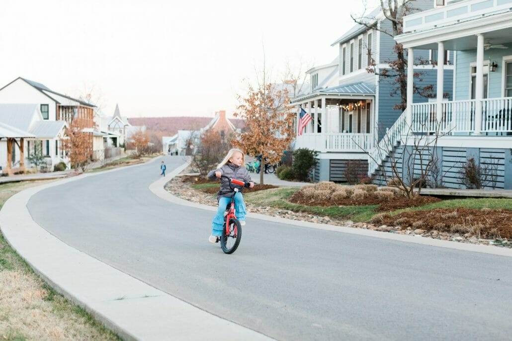 girl riding a bike up street