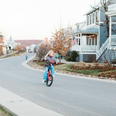 girl riding a bike up street